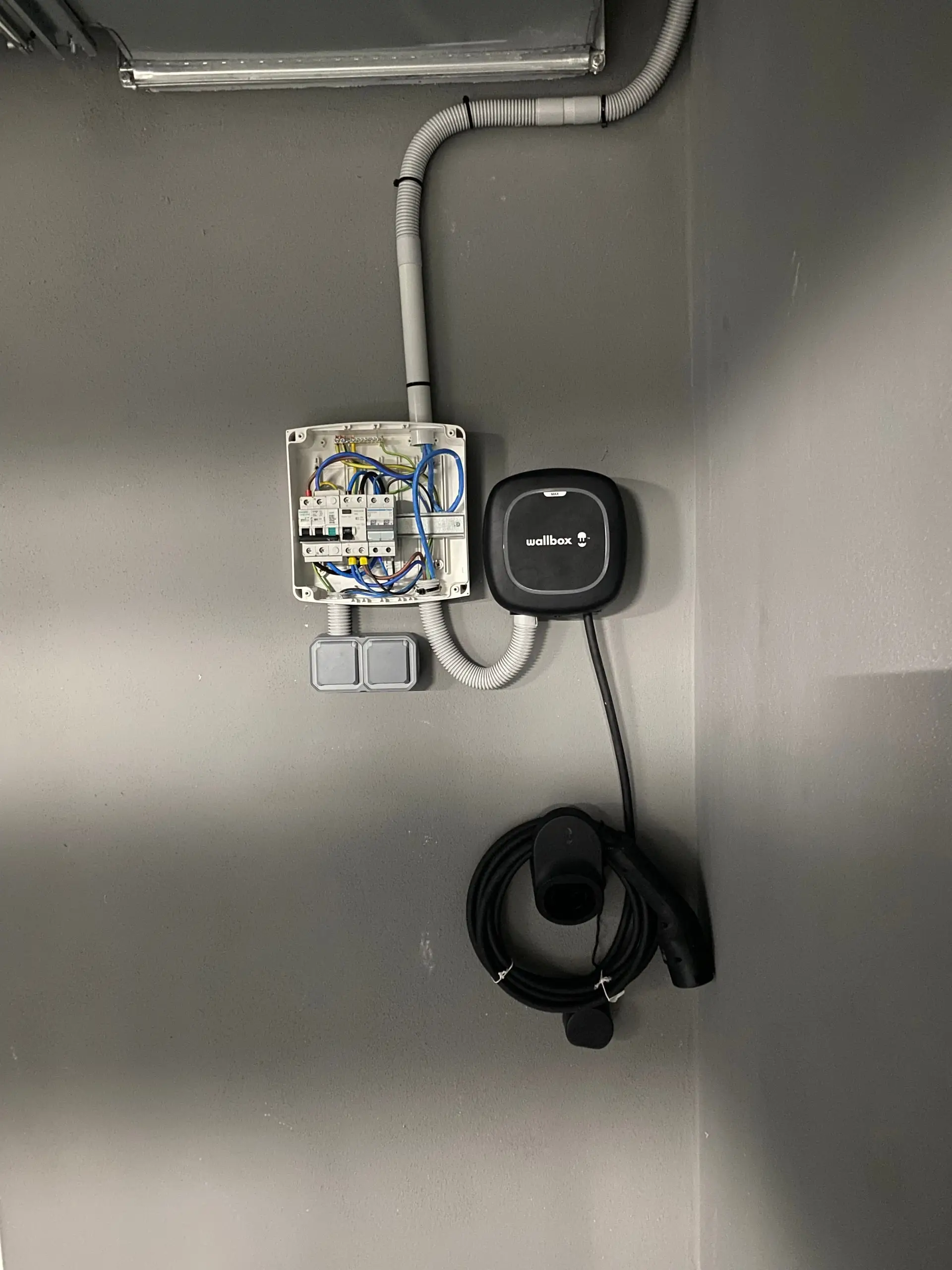 Completed electric car charger installation: Wallbox, protection box and Type 2 cable